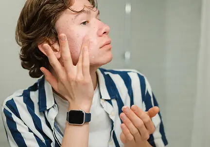 Person applying skincare products to their face