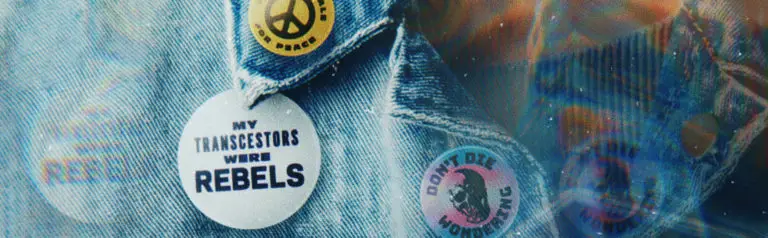 Denim jacket with pins reading “My Transcestors Were Rebels,” “Don’t Die Wondering,” and a peace sign. Banner for transgender history spotlight blog series for Plume Clinic.