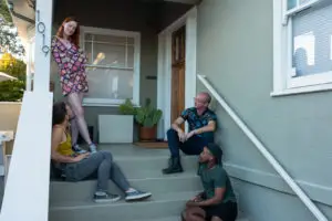 group of transgender friends hanging out on the porch during pride