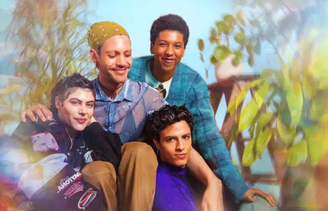 A group of trans and non-binary people sitting closely, surrounded by a rainbow glow