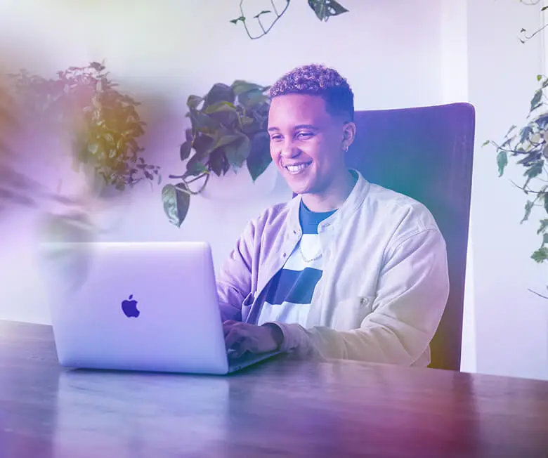 person on a laptop computer smiling